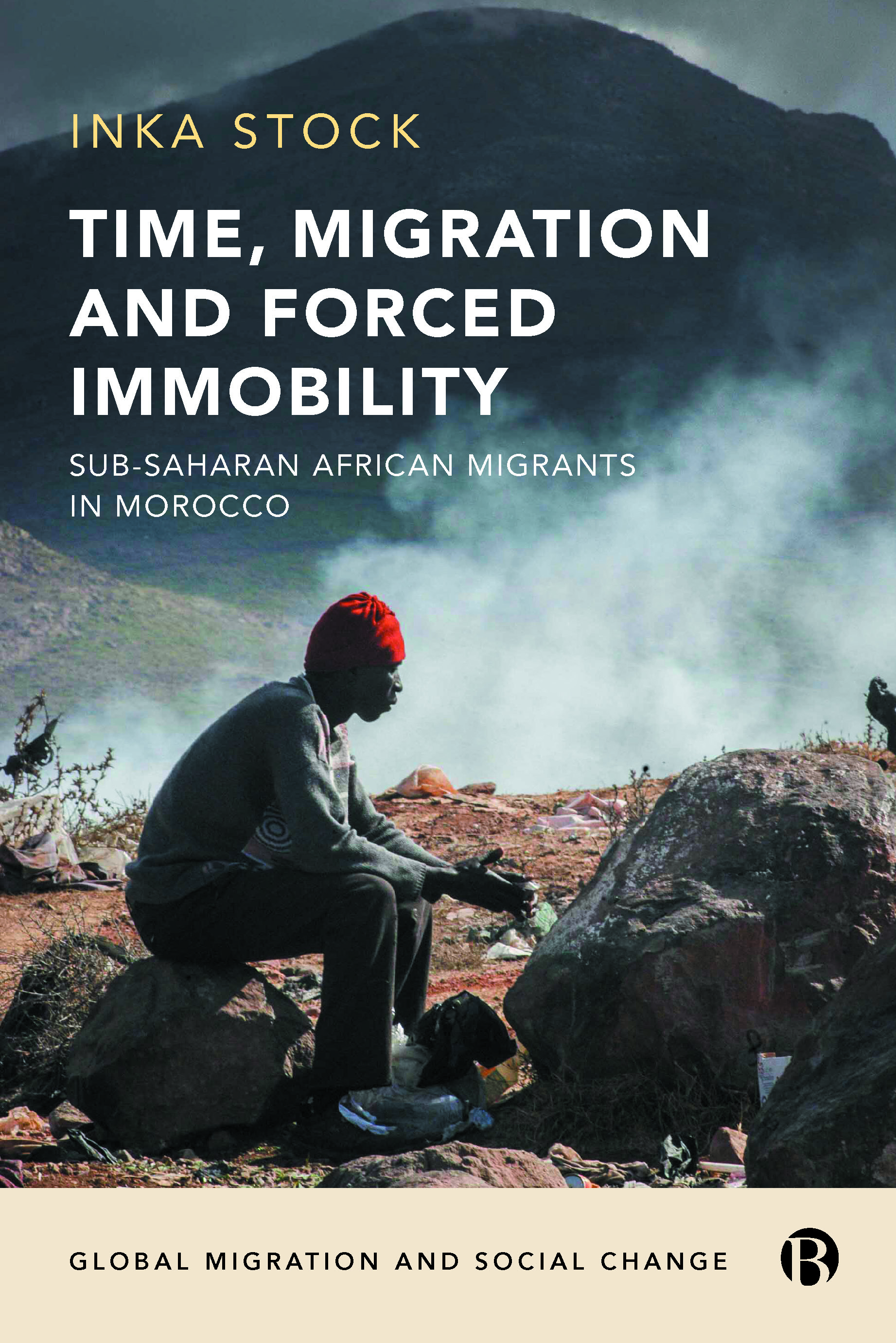 cover image of the book; man sitting on a rock next to a mountain range in Sub-Saharan Africa